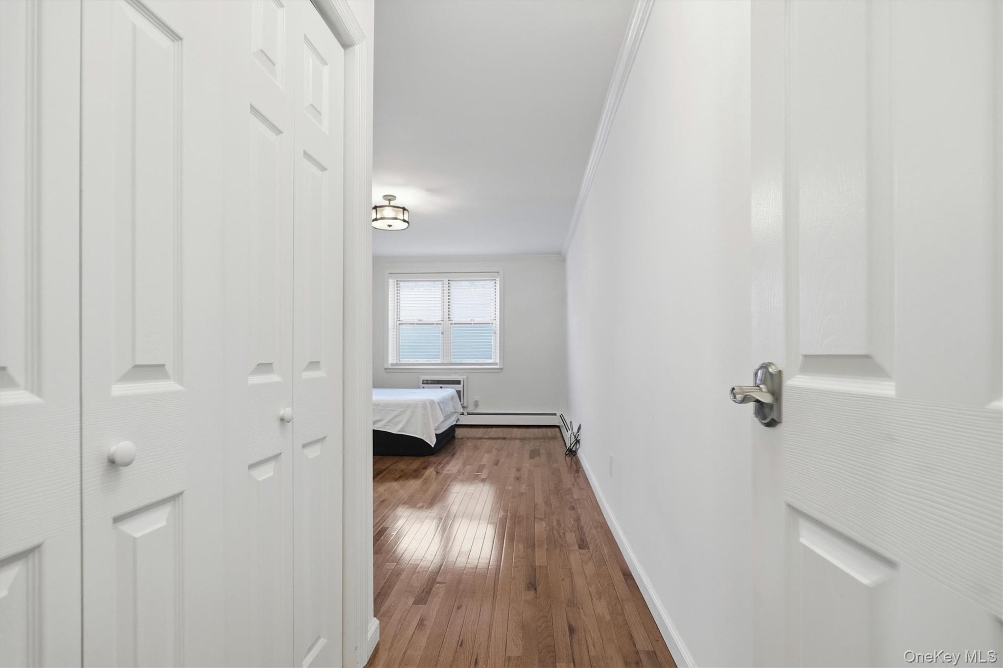 25 Chapel Place, Unit 1B Great Neck, NY 11021 - Photo 12 of 33 a view of a room with wooden floor and a bathroom view