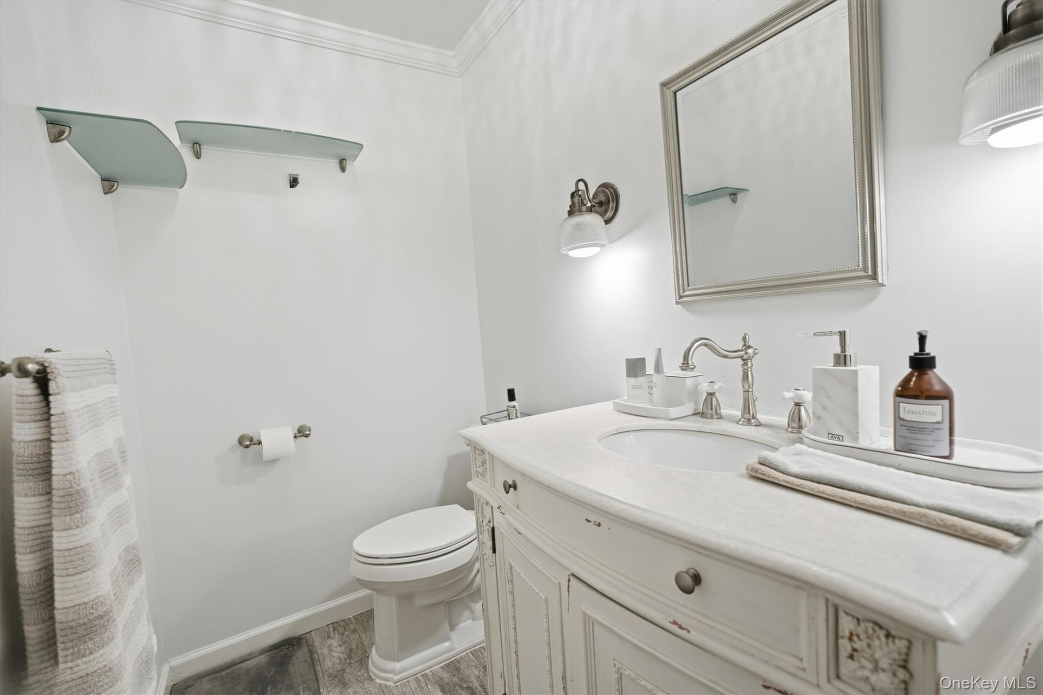 25 Chapel Place, Unit 1B Great Neck, NY 11021 - Photo 18 of 33 a bathroom with a granite countertop sink mirror vanity and toilet