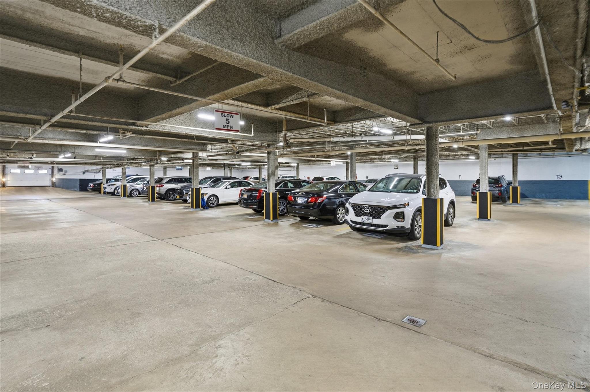 25 Chapel Place, Unit 1B Great Neck, NY 11021 - Photo 24 of 33 a view of parking garage with cars