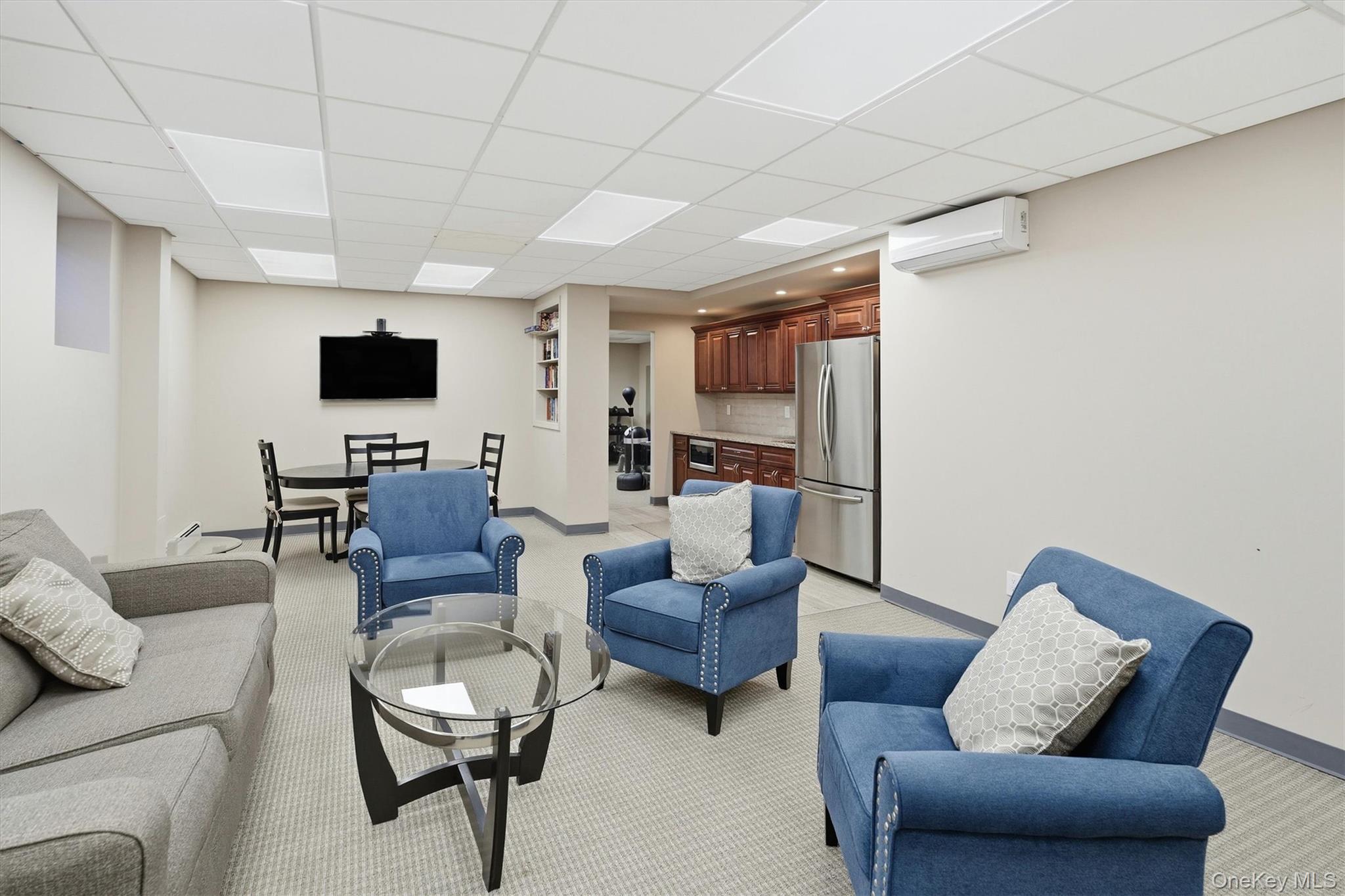 25 Chapel Place, Unit 1B Great Neck, NY 11021 - Photo 26 of 33 a living room with furniture a flat screen tv and kitchen view