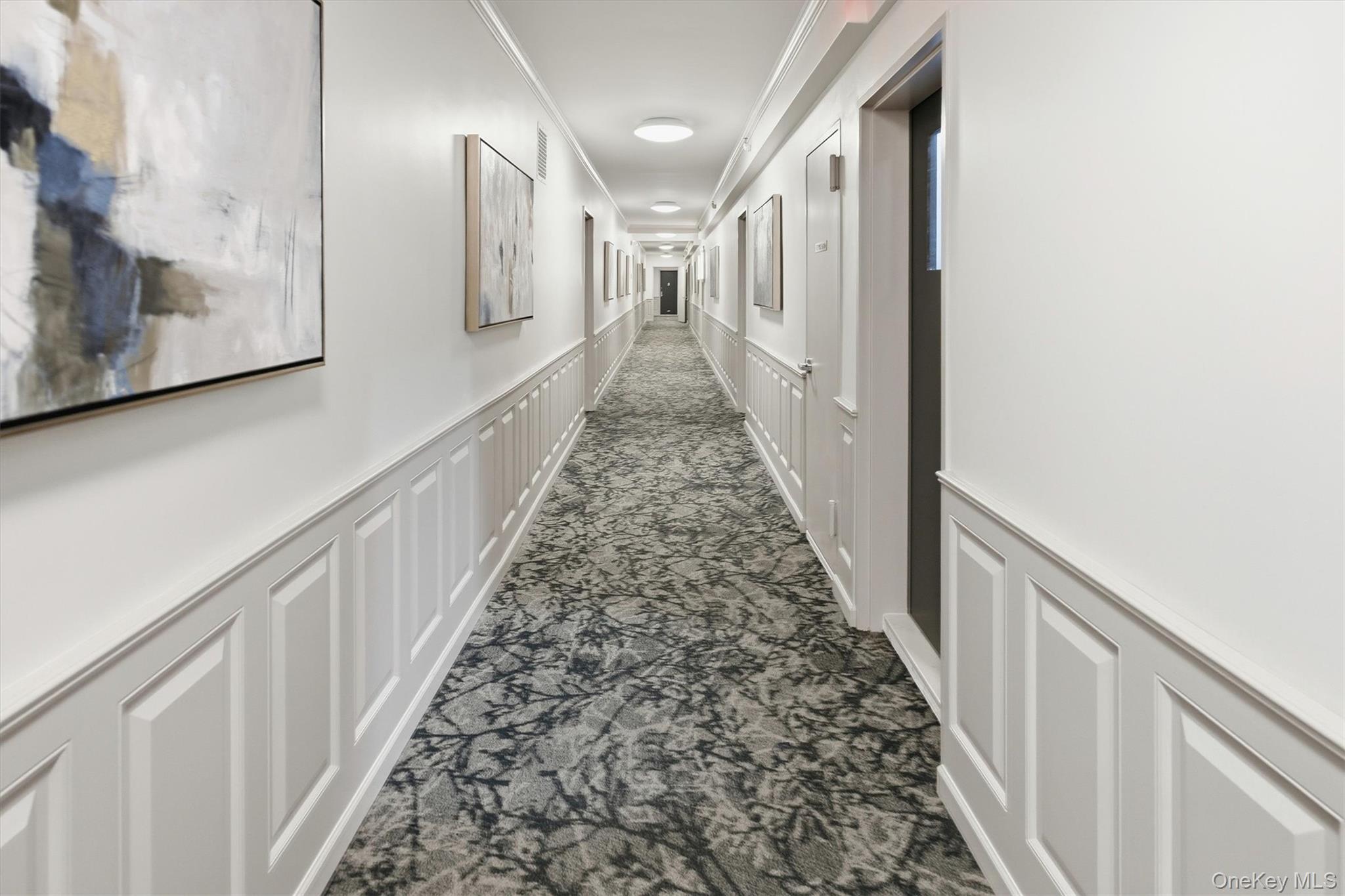 25 Chapel Place, Unit 1B Great Neck, NY 11021 - Photo 30 of 33 a view of a hallway with wooden floor and staircase