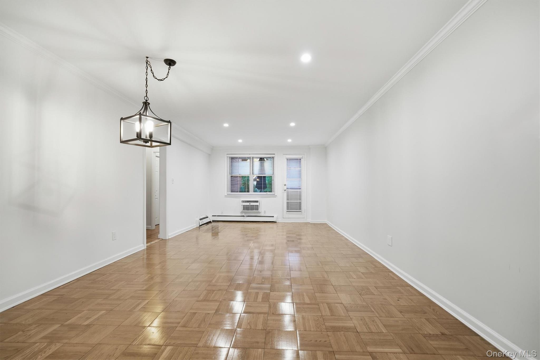 25 Chapel Place, Unit 1B Great Neck, NY 11021 - Photo 5 of 33 a view of empty room with wooden floor and window