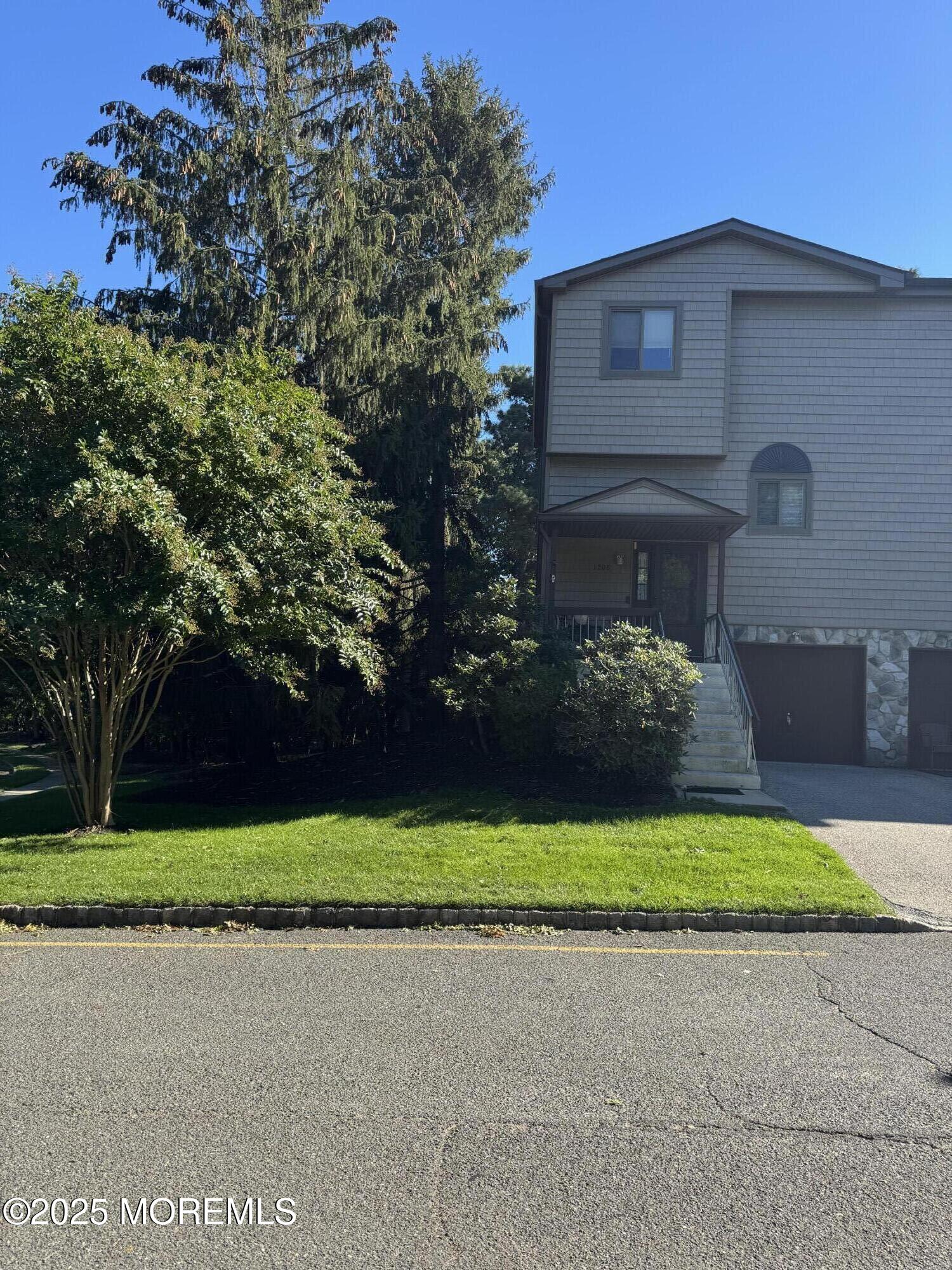 1208 Alpine Trail Neptune Township, NJ 07753 - Photo 4 of 29 a front view of a house with a yard and garage