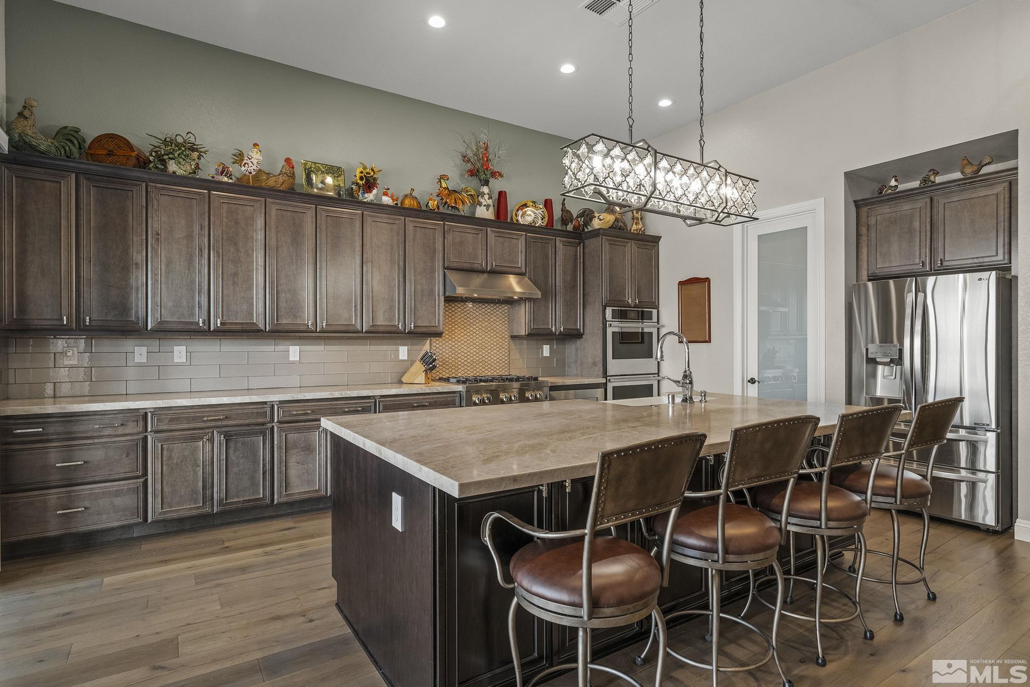 2455 Buttermere Court Reno, NV 89521 - Photo 11 of 38 a kitchen with wooden cabinets and center island