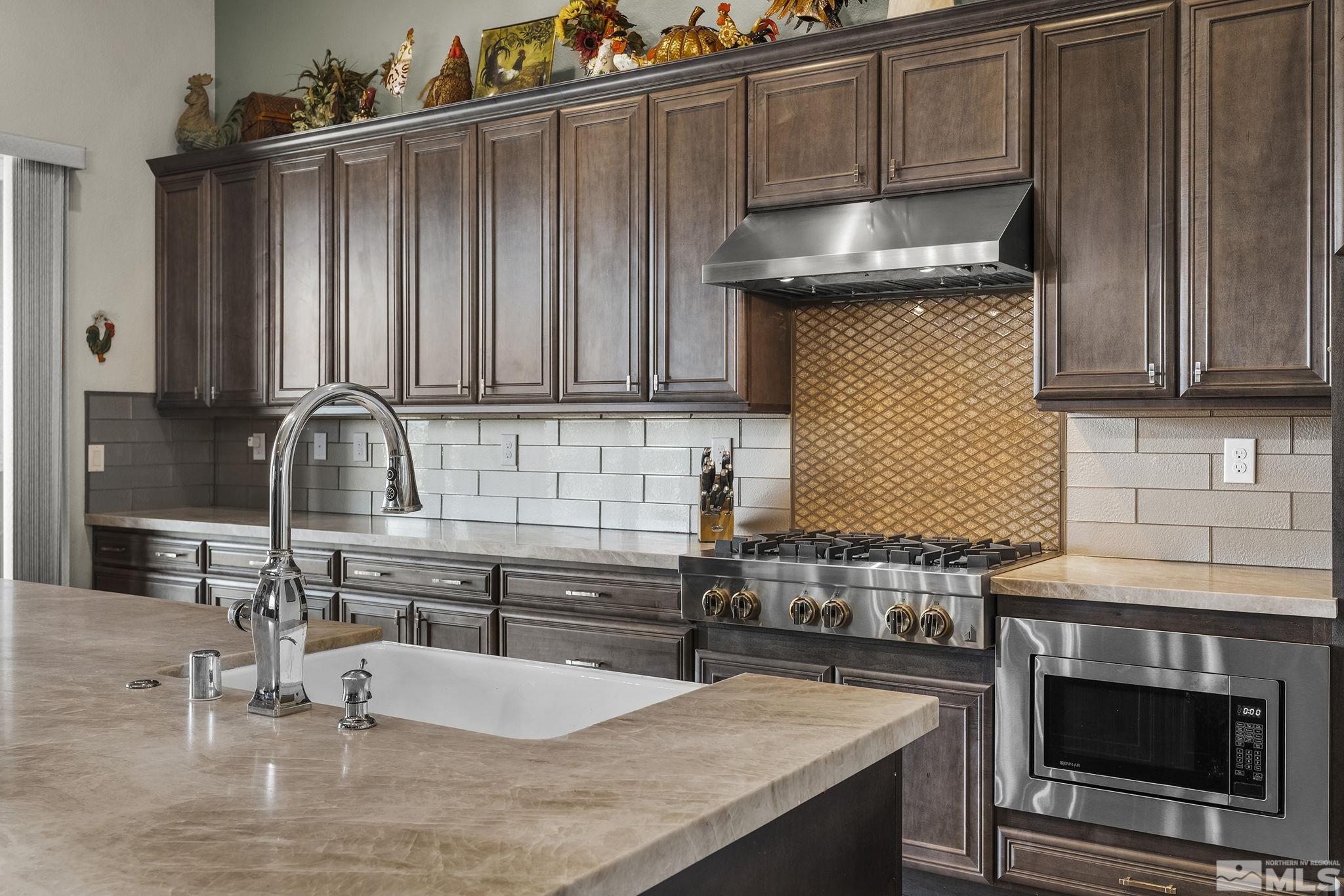 2455 Buttermere Court Reno, NV 89521 - Photo 12 of 38 a kitchen with granite countertop a sink a stove and cabinets