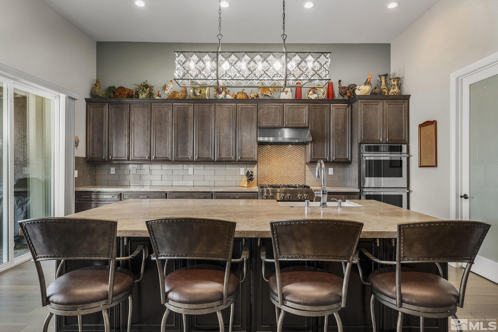 2455 Buttermere Court Reno, NV 89521 - Photo 10 of 38 a kitchen with a dining table chairs and a chandelier