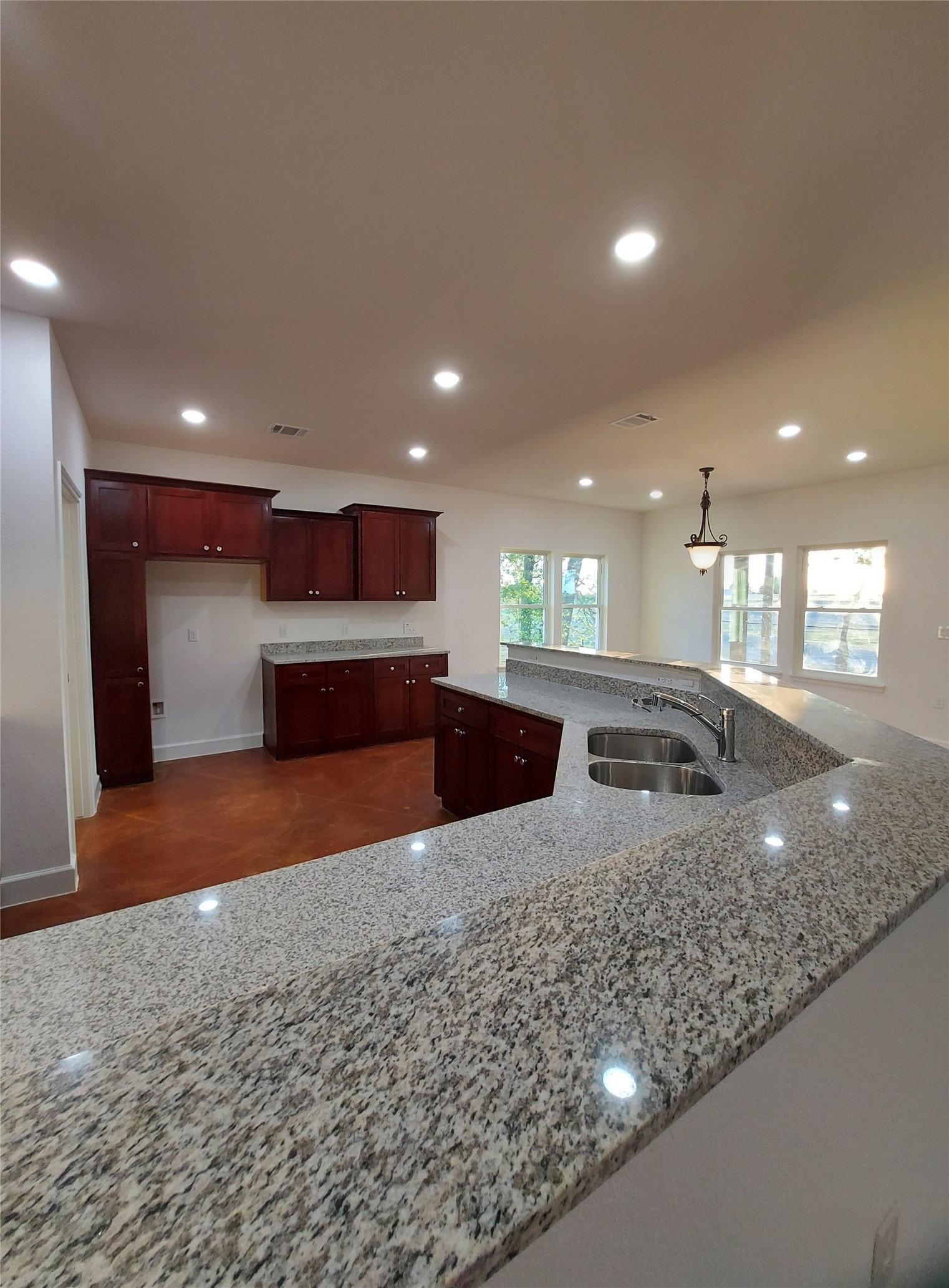 121 Spanish Oak Trail Cameron, TX 76520 - Photo 13 of 36 a kitchen with stainless steel appliances granite countertop a sink a stove and a refrigerator