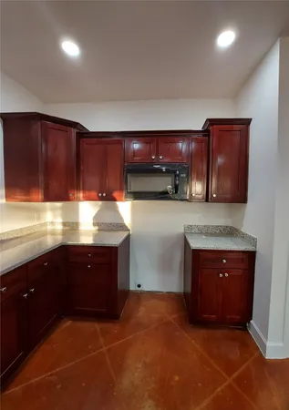 a kitchen with stainless steel appliances granite countertop a sink and a stove top oven