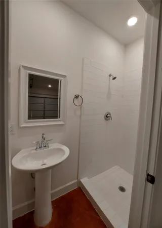 an empty room with windows and ceiling fan view