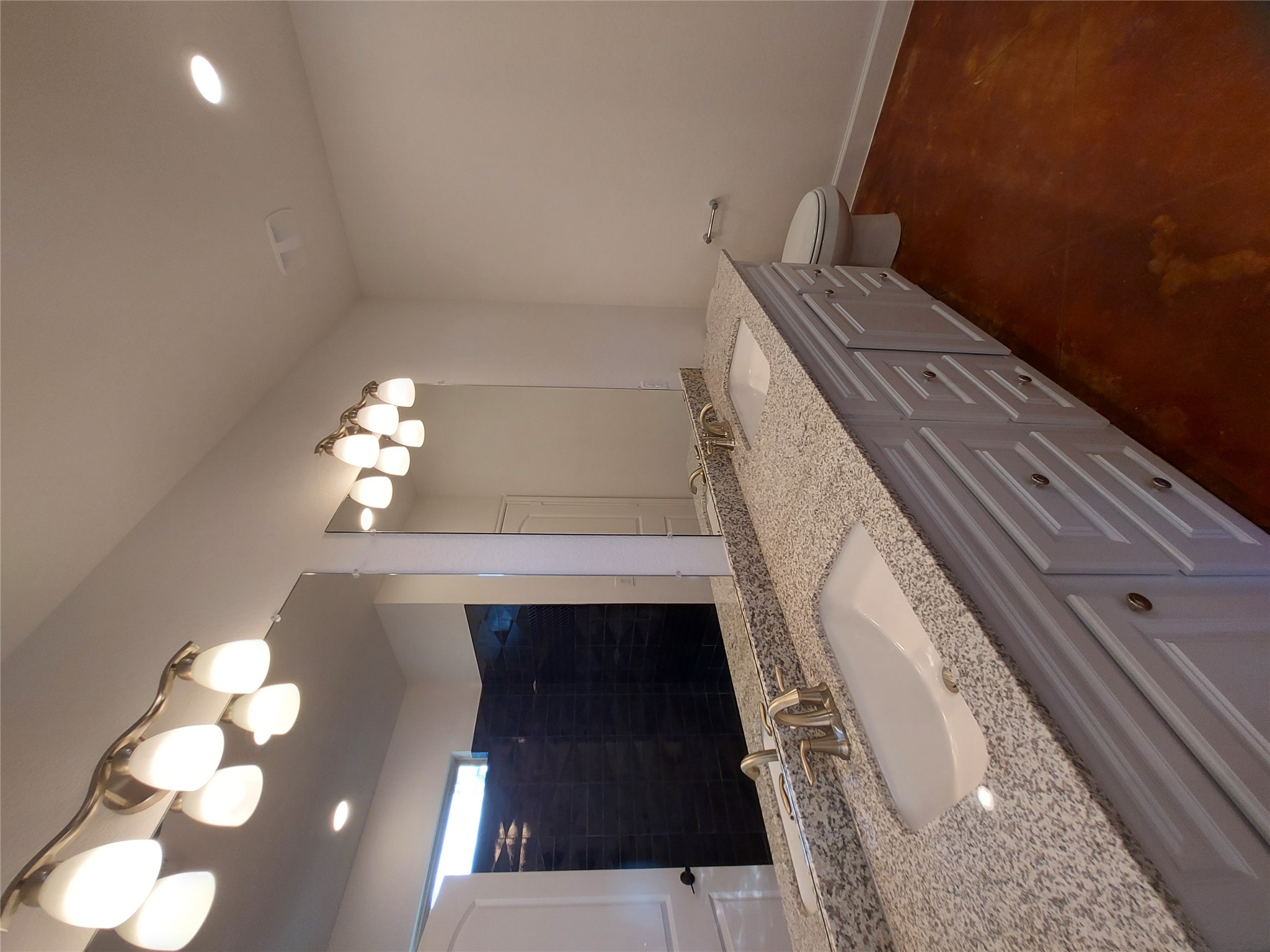 121 Spanish Oak Trail Cameron, TX 76520 - Photo 29 of 36 a bathroom with a granite countertop sink a large mirror and vanity