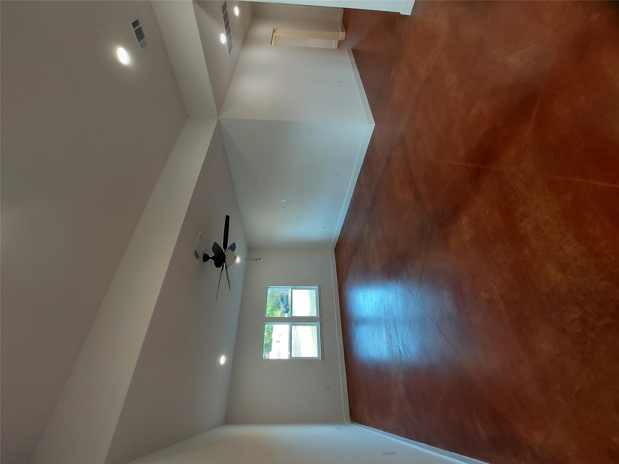 121 Spanish Oak Trail Cameron, TX 76520 - Photo 5 of 36 an empty room with wooden floor and windows in it