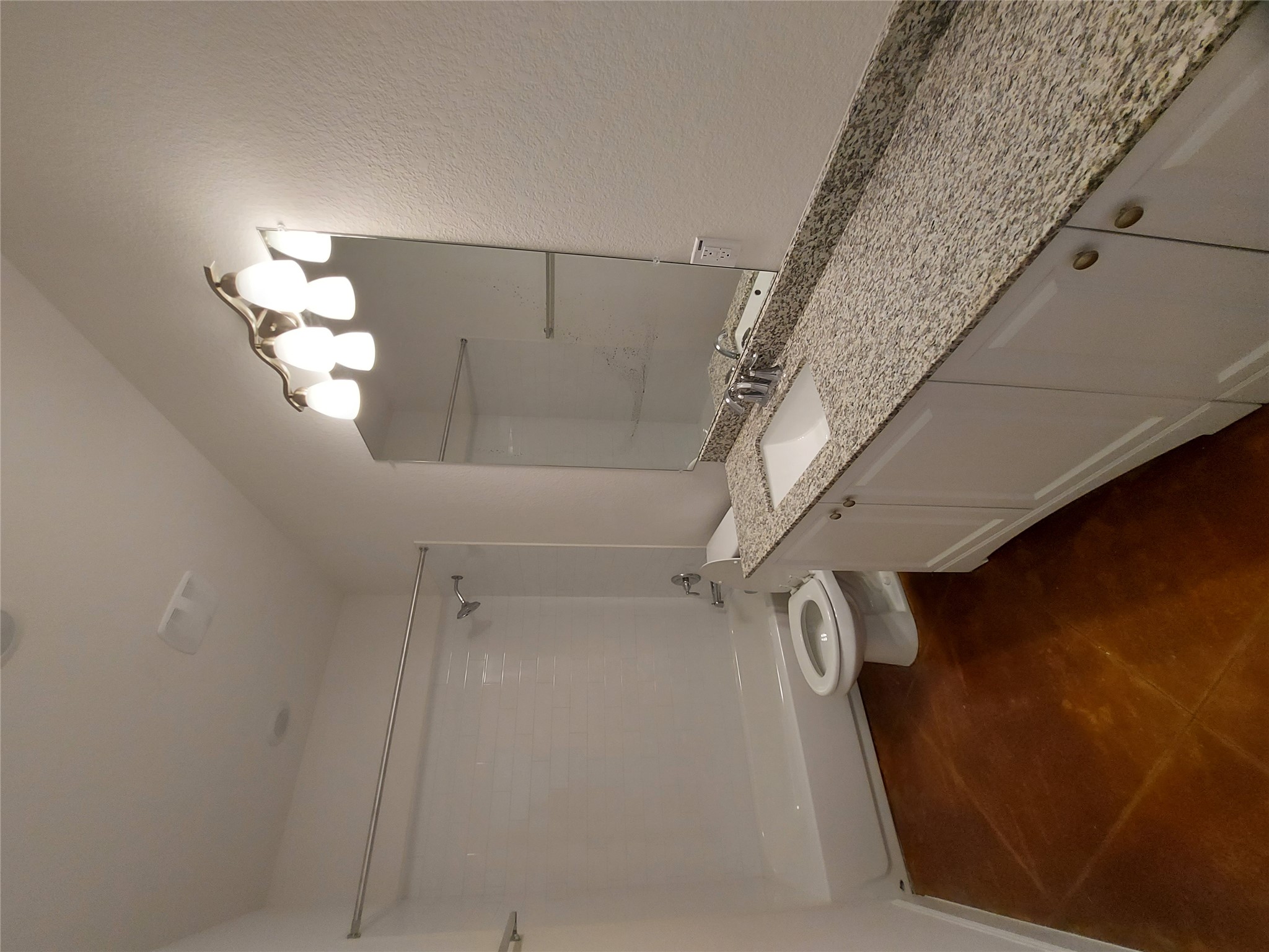 121 Spanish Oak Trail Cameron, TX 76520 - Photo 7 of 36 a bathroom with a granite countertop sink a toilet and a mirror