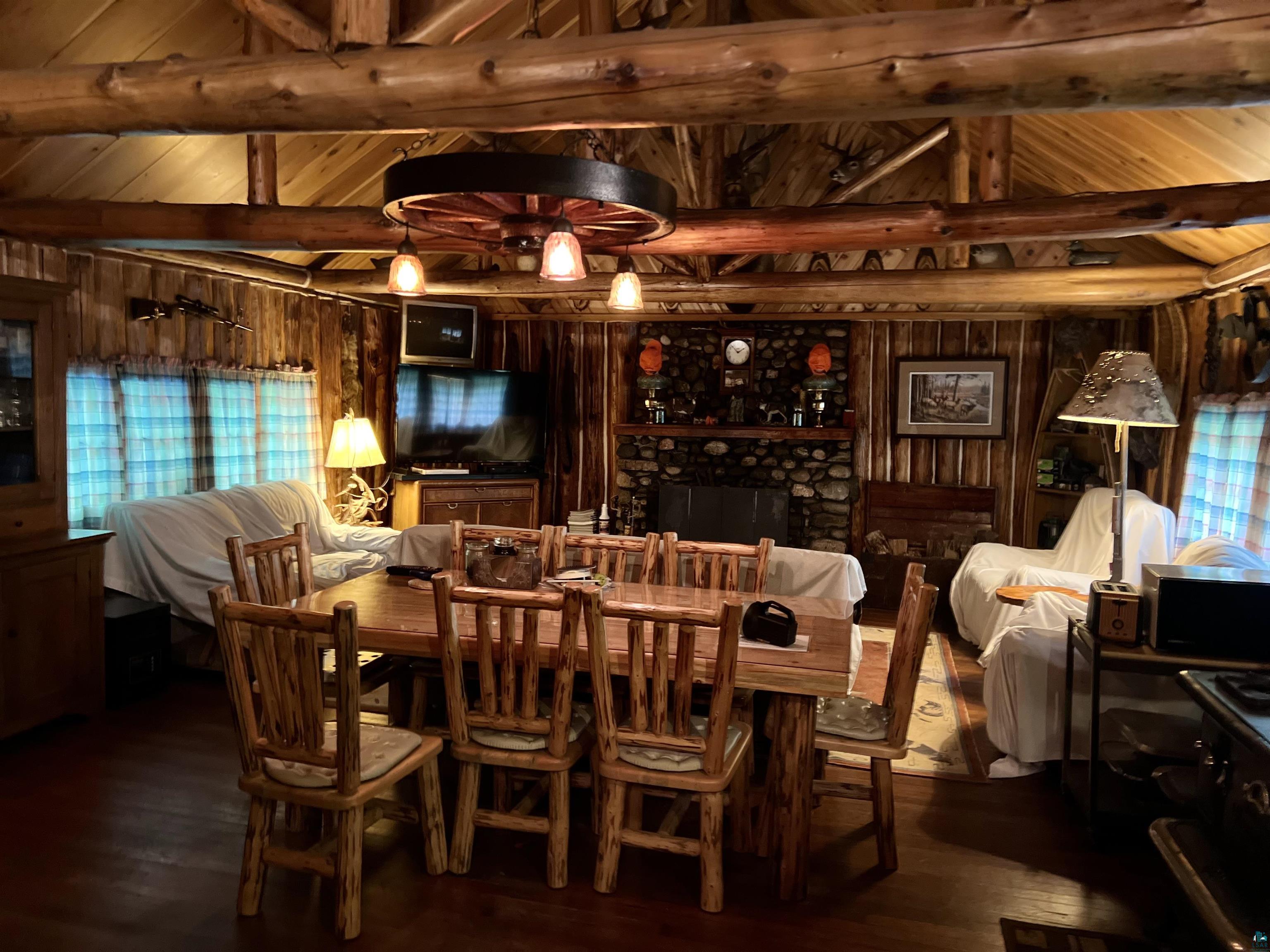 26336 Forest Road 181 Glidden, WI 54527 - Photo 11 of 18 Dining space featuring plenty of natural light, lofted ceiling with beams, and hardwood / wood-style floors