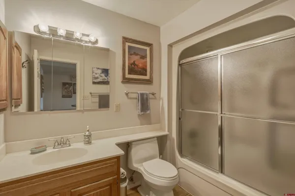 a bathroom with a glass shower door