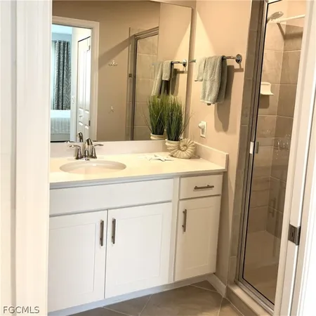 a bathroom with a sink vanity mirror and a