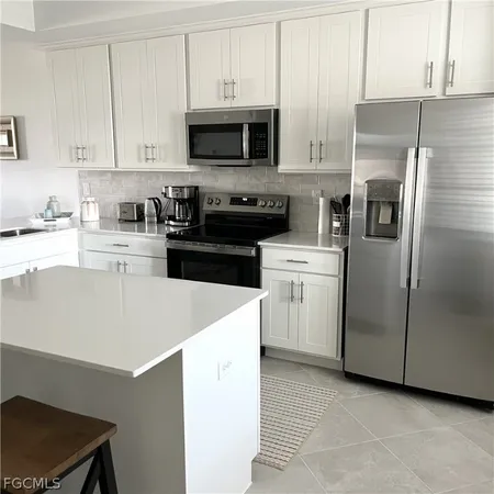 a kitchen with a sink a stove and cabinets