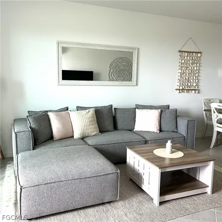 a living room with a couch and painting on the wall