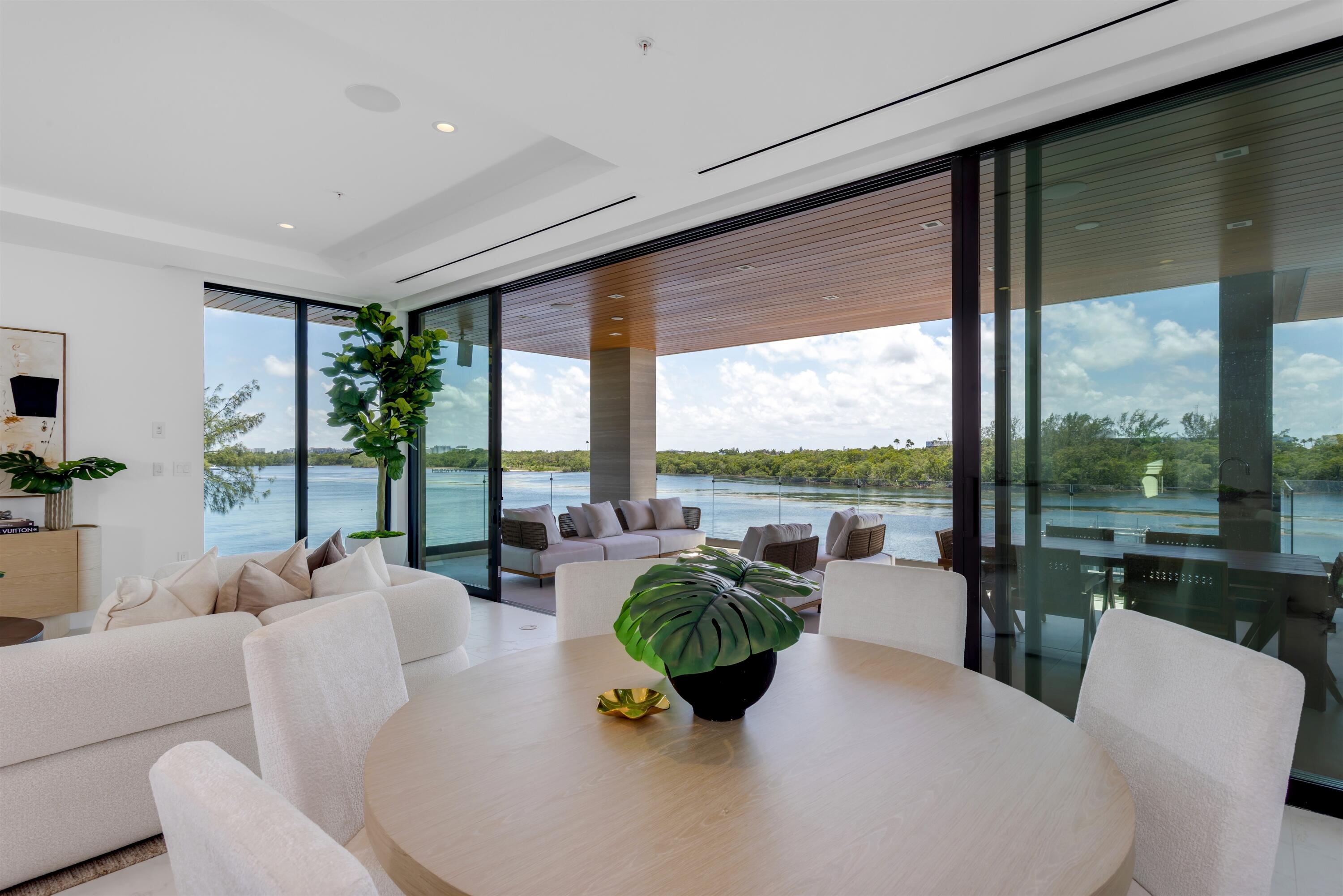 900 Lago Mar Lane, Unit PH Boca Raton, FL 33431 - Photo 11 of 58 a living room with furniture and floor to ceiling windows
