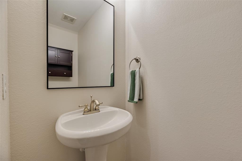 11920 Vienna Apple Road Fort Worth, TX 76244 - Photo 25 of 40 Downstairs powder bathroom at 11920 Vienna Apple in Villages of Woodland Springs community in North Fort Worth