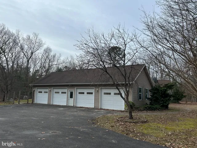 a house that has a tree in front of it