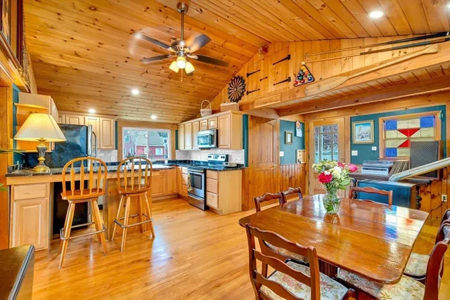 a dining room with lots of wooden furniture