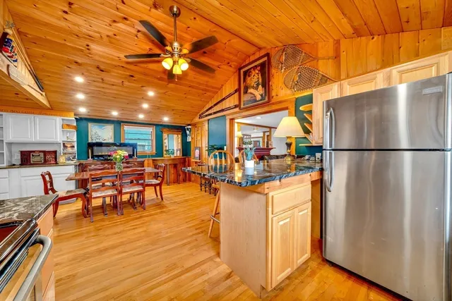 a dining room with furniture and a kitchen view