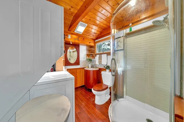 a bathroom with a toilet and a shower