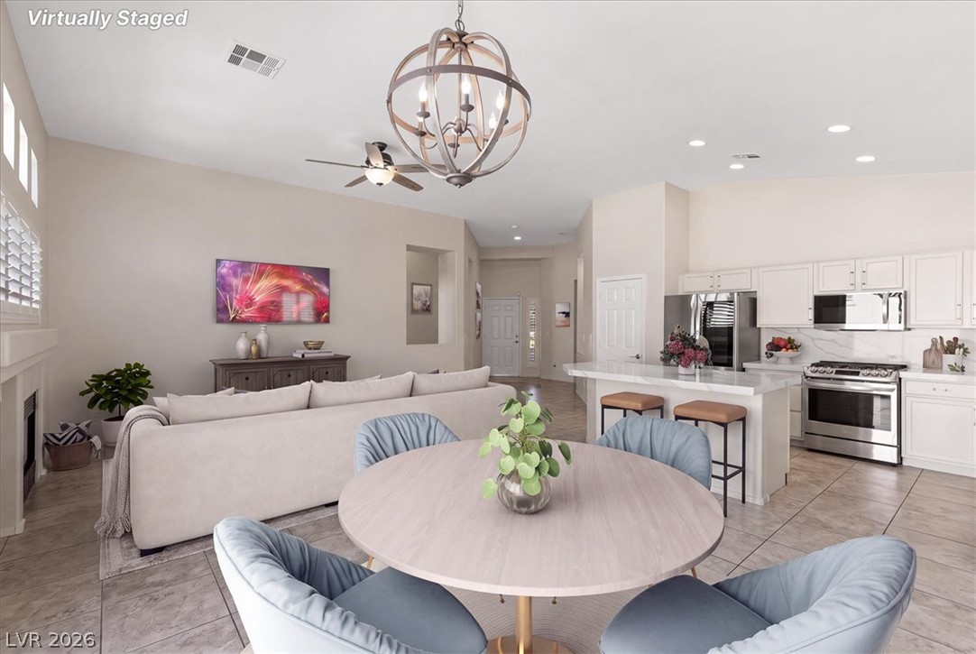 1007 Golden Ridge Court Henderson, NV 89052 - Photo 6 of 27 Tiled flooring and high ceilings elevate this open living and dining area.