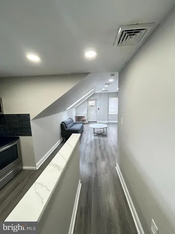 a view of a living room with wooden floor