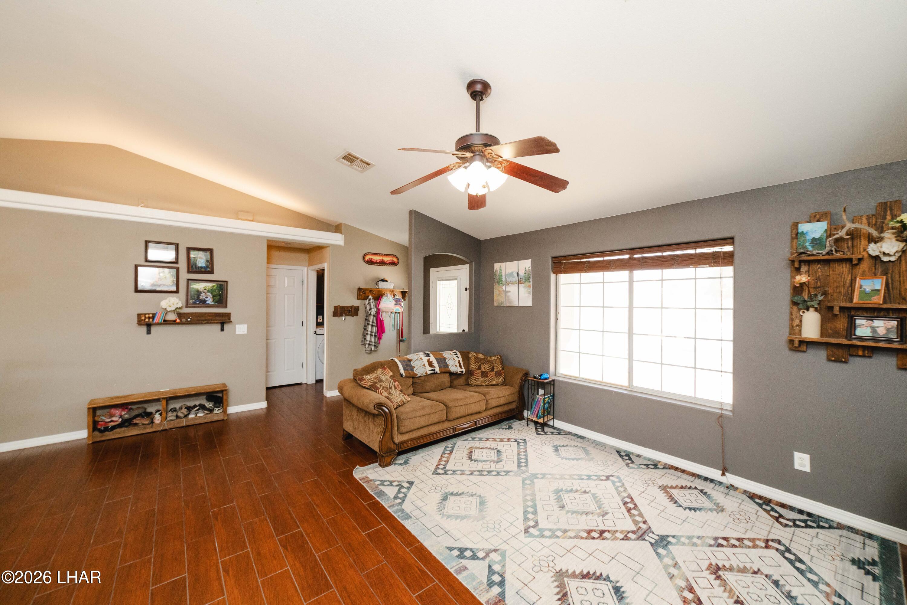 2177 Ridgeview Road Kingman, AZ 86401 - Photo 12 of 43 Living area featuring wood-finish flooring, vaulted ceilings, and a ceiling fan