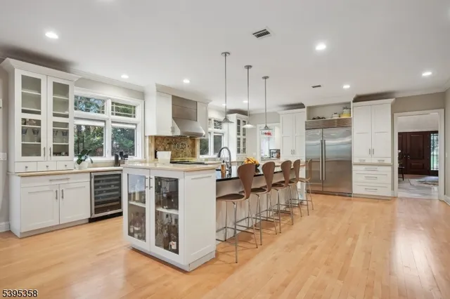 a large white kitchen with lots of counter space and a dining table