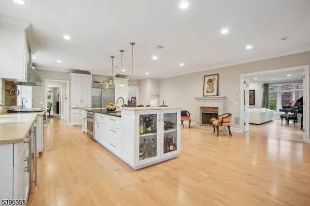a large white kitchen with lots of furniture and appliances