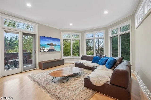 a view of a living room with furniture and wooden floor