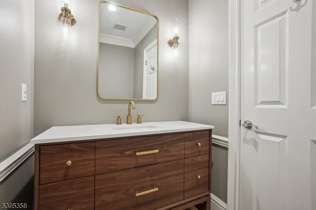 a bathroom with a tub sink shower and mirror
