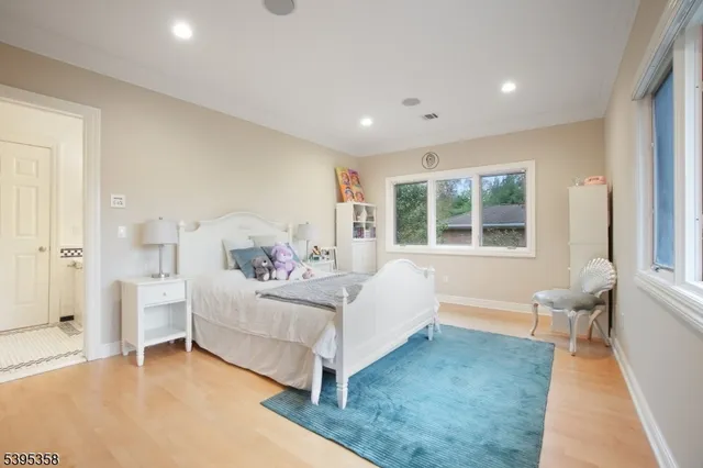 a bathroom with a sink a toilet a mirror and shower