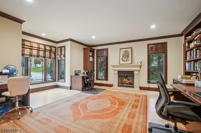 a view of a livingroom with furniture fireplace and a window