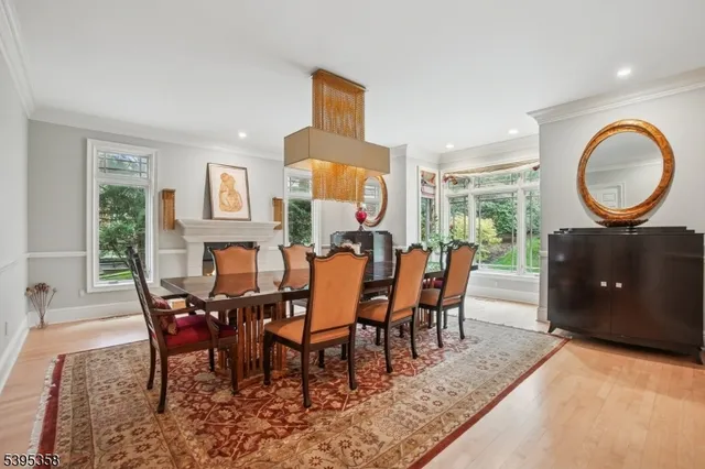 a dining room with furniture a chandelier and a rug