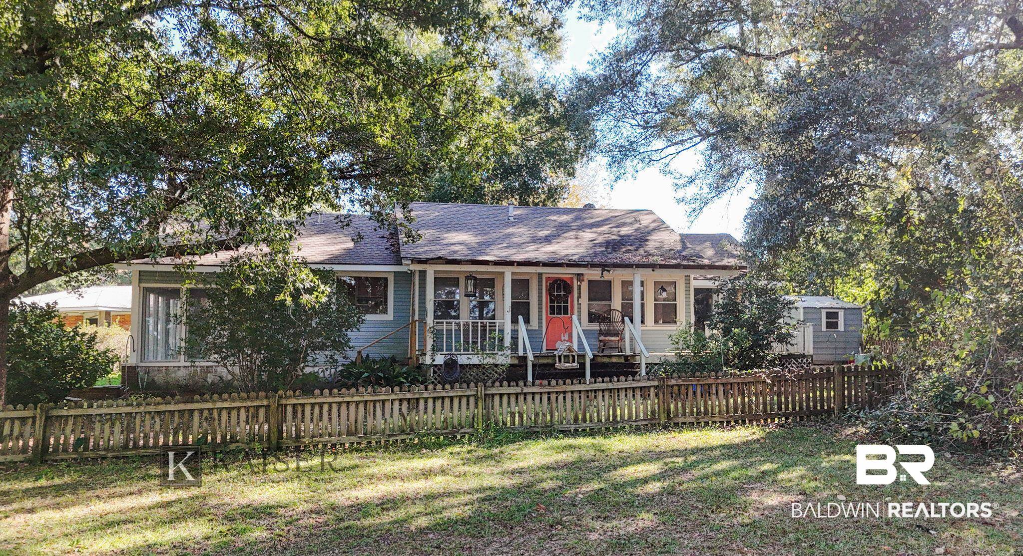 18696 Borck Road Gulf Shores, AL 36542 - Photo 36 of 47 View of front facade with a porch and a front yard
