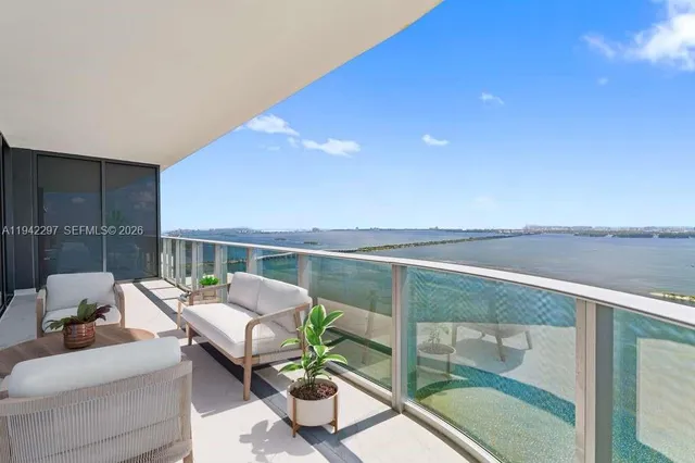 a balcony with furniture and a potted plant