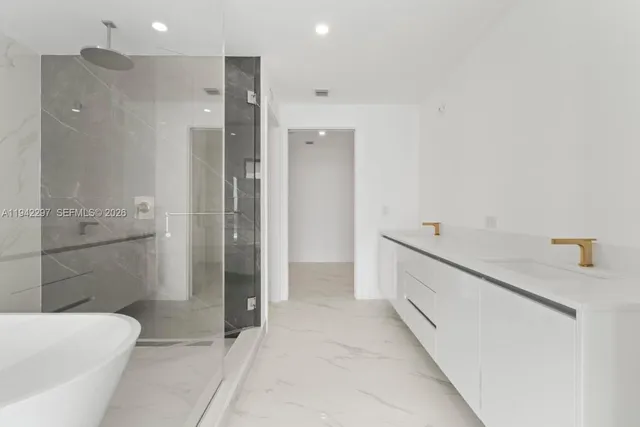a bathroom with a bathtub and a shower