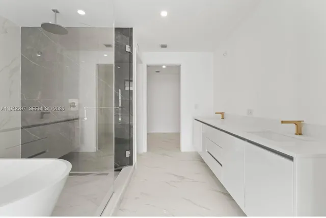 a bathroom with a granite countertop sink a toilet and shower