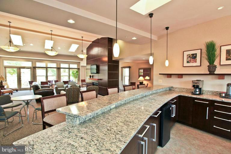 1785 Jonathan Way, Unit B Reston, VA 20190 - Photo 27 of 35 a kitchen with granite countertop a stove a sink a dining table and chairs with wooden floor