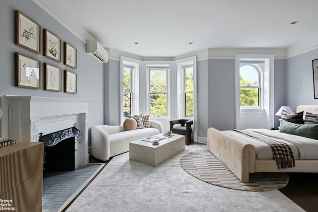 a kitchen with stainless steel appliances granite countertop a stove a refrigerator a kitchen island a sink dishwasher and white cabinets with wooden floor