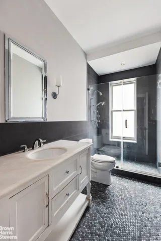 a spacious bedroom with a bed a couch and a window