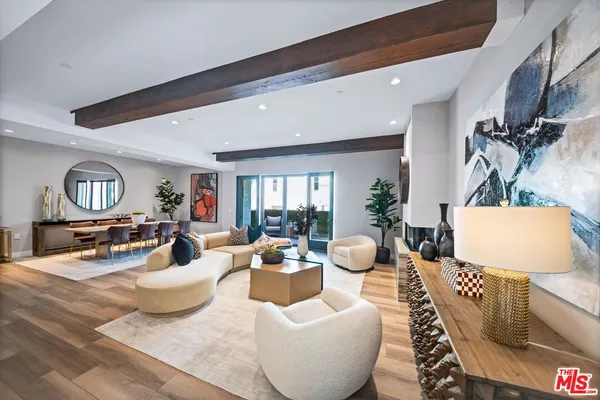 a living room with fireplace furniture and a wooden floor
