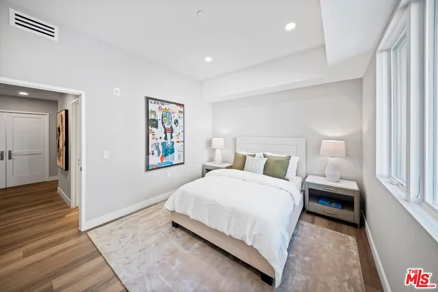 a bedroom with a large bed and a window