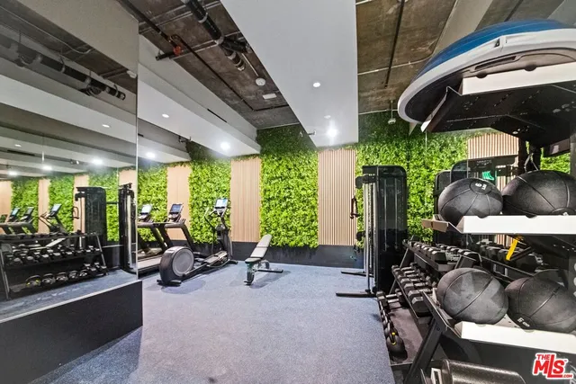 a living room with patio furniture and a potted plant