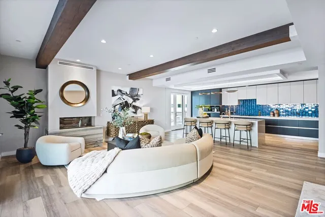 a living room with fireplace furniture and wooden floor