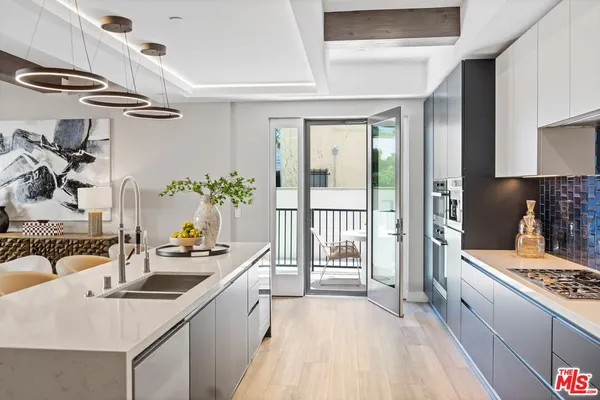 a kitchen that has a sink and a stove