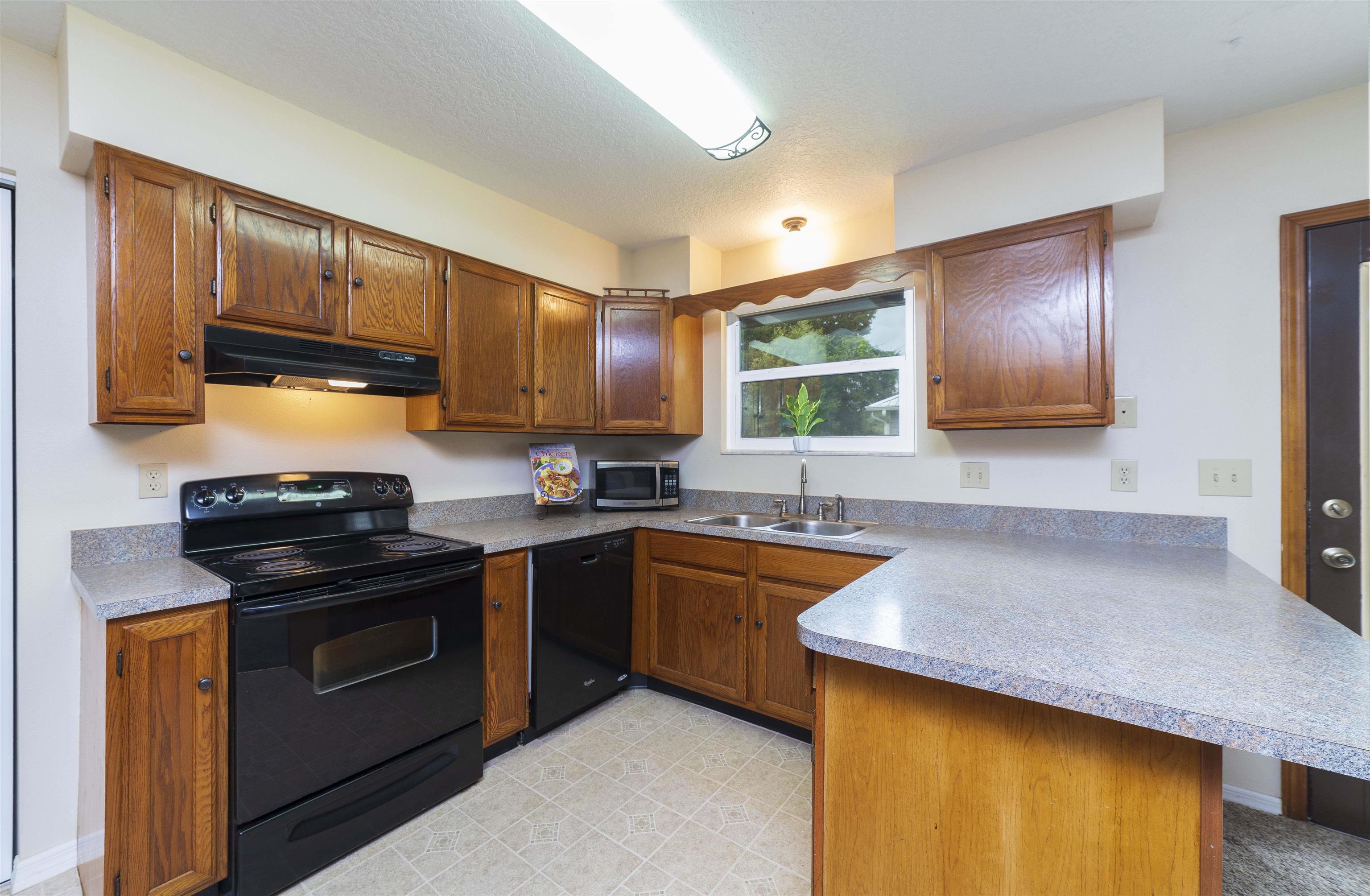 208 Jasmine Road St. Augustine, FL 32086 - Photo 11 of 34 a kitchen with granite countertop stainless steel appliances and wooden cabinets